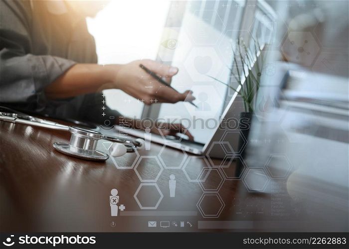 doctor working with laptop computer in medical workspace office and medical network media diagram with glass of water and green plant foreground as concept