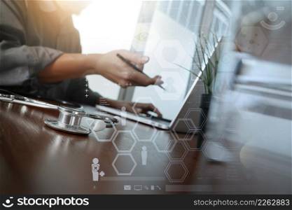 doctor working with laptop computer in medical workspace office and medical network media diagram with glass of water and green plant foreground as concept