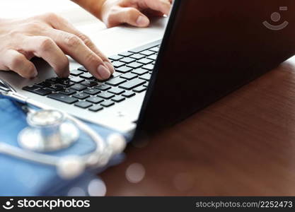 Doctor working with laptop computer in medical workspace office as concept