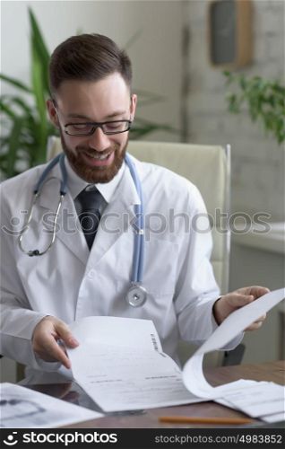 Doctor working with test results of his patient at his office