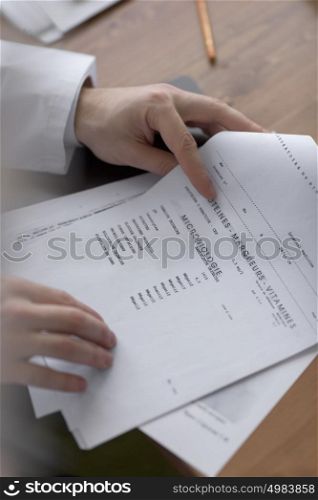 Doctor working with test results of his patient at office
