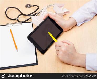 doctor works with tablet pc during appointment