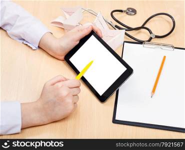 doctor works with tablet pc with cut out screen