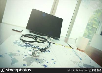 Doctor workspace with laptop computer in medical workspace office and medical network media diagram as concept