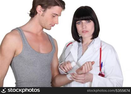 Doctor wrapping gauze around wrist