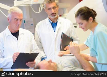 doctors and nurse checking on patient in hospital