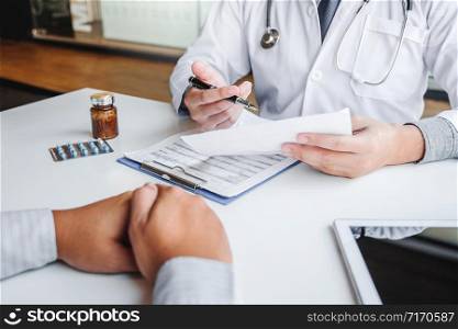 Doctors and patients consulting and diagnostic examining sit and talk. At the table near the window in the hospital medicine concept