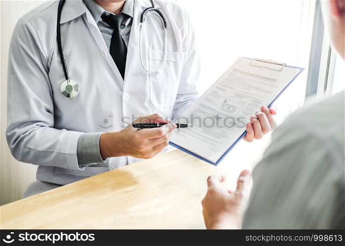 Doctors and patients sit and talk to the patient about medication. At the table near the window in the hospital.