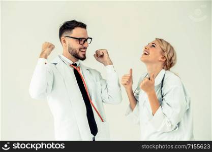 Doctors at hospital working with partner. Healthcare and medical services.. Happy doctor celebrates success with partner.