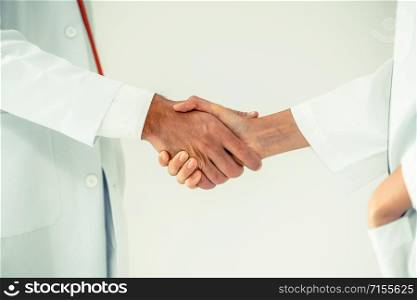 Doctors at hospital working with partner. Healthcare and medical services.. Doctor at hospital shakes hand with another doctor