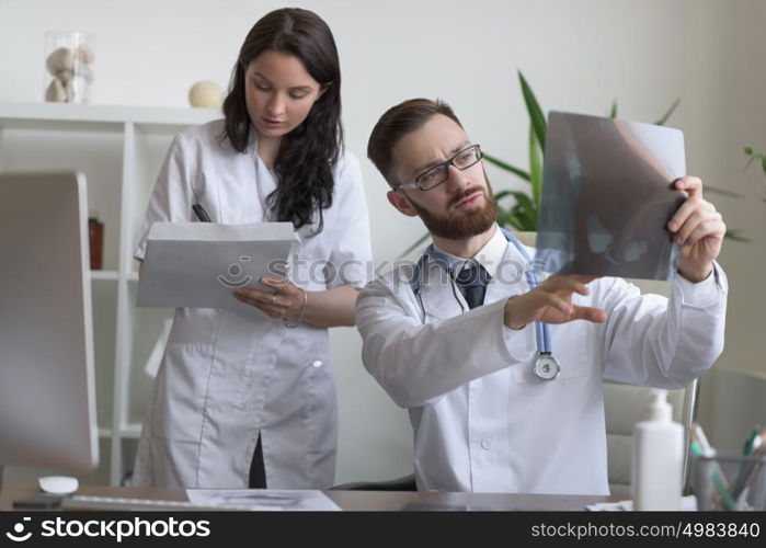 Doctors discussing intestines xray at medical office