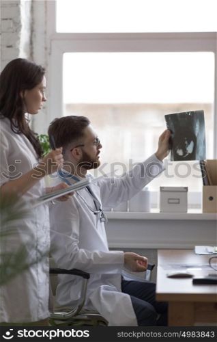 Doctors discussing intestines xray at medical office