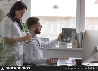 Doctors discussing intestines xray at medical office