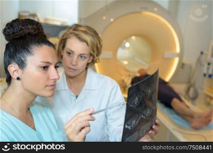 doctors discussing intestines xray at medical office