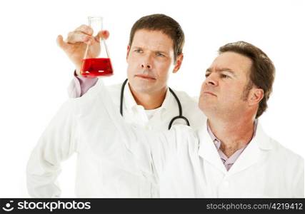 Doctors examining a blood sample in a laboratory flask. Isolated on white.