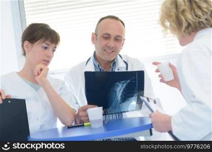 doctors examining an xray at a coffee break