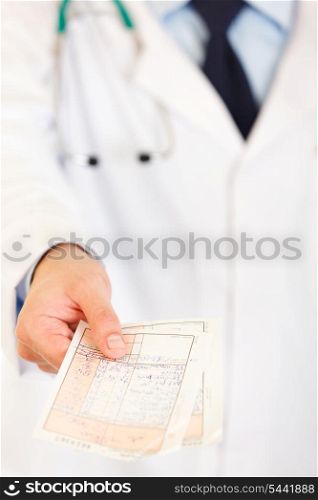 Doctors hand holding medical prescription isolated on white. Close-up.&#xA;