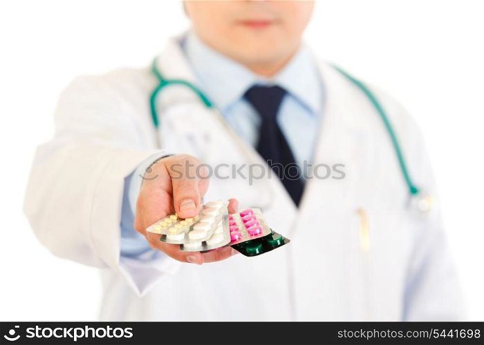 Doctors hand holding packs of pills isolated on white. Close-up.&#xA;