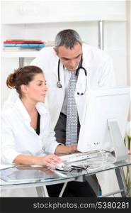 Doctors looking at a computer