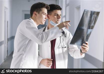 doctors looking x ray hallway