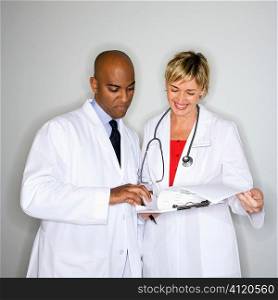 Doctors reading paperwork.