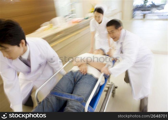 Doctors rushing patient in