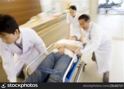 Doctors rushing patient in