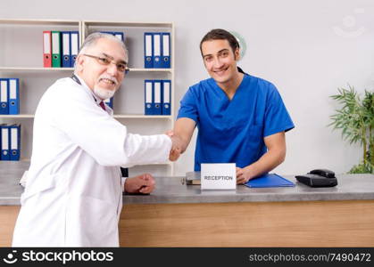 Doctors talking at the reception in hospital. Two doctors talking at the reception in hospital