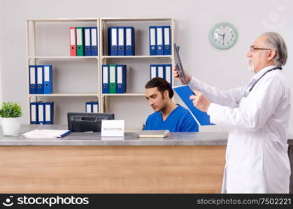 Doctors talking at the reception in hospital. Two doctors talking at the reception in hospital