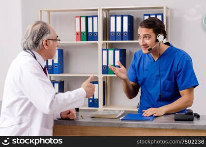 Doctors talking at the reception in hospital. Two doctors talking at the reception in hospital