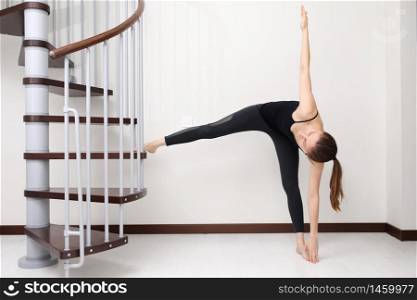 Does exercises. Young woman with slim body shape in sportswear have fitness day indoors at home. stay at home concept. Does exercises. Young woman with slim body shape in sportswear have fitness day indoors at home. stay at home concept.