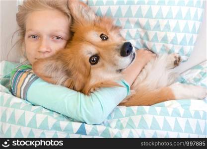 dog corgi little girl sleeping in sleep mask. child and dog