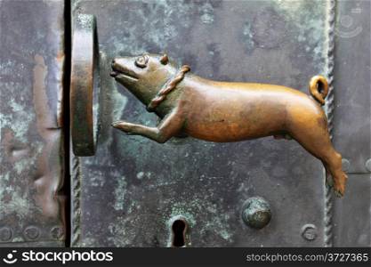Dog leaping through a ring - antique door handle