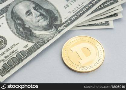 Dogecoin coin and a pile of US dollar banknotes. Blockchain money versus fiat money concept