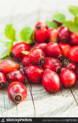 Dogrose fruits on the wooden table close up