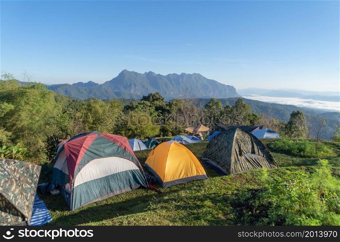 Doi Luang Chiang Dao, Chiang Mai, Thailand with camping tents and forest trees and green mountain hills. Nature landscape background.