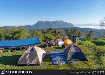 Doi Luang Chiang Dao, Chiang Mai, Thailand with camping tents and forest trees and green mountain hills. Nature landscape background.