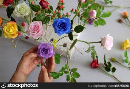 Doing clay flower with clay art, colorful roses flower on white background, beautiful artificial flowers of craft