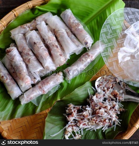 Doing Vietnamese egg roll or spring rolls or cha gio, is popular food at Vietnam cuisine, stuffing from meat and wrapper by rice paper