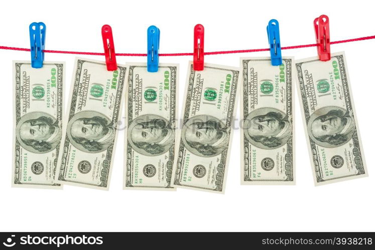 Dollar banknotes hanging on laundry line attached with plastic clothespins