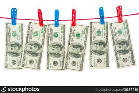 Dollar banknotes hanging on laundry line attached with plastic clothespins