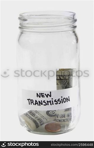 Dollar bills and coins in a jar