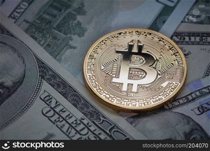 Dollar bills and gold coin bitcoin. Cryptocurrency business concept. Conceptual image for worldwide cryptocurrency and digital payment system.. Dollar bills and gold coin bitcoin. Cryptocurrency business concept.