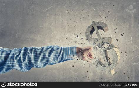 Dollar concept. Hand of businessman crashing stone dollar sign with fist