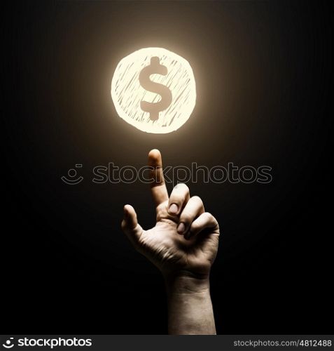 Dollar concept. Human finger pointing at dollar sign on black background