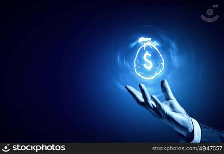 Dollar concept. Person hand holding money concept on blue background