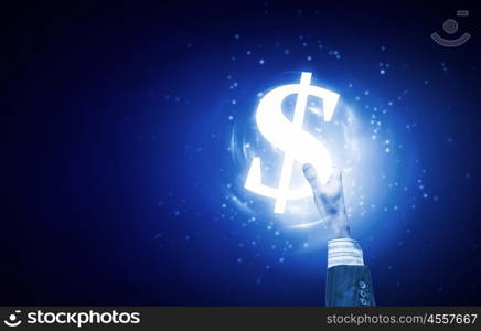 Dollar currency. Close up of human hand holding dollar symbol on blue background
