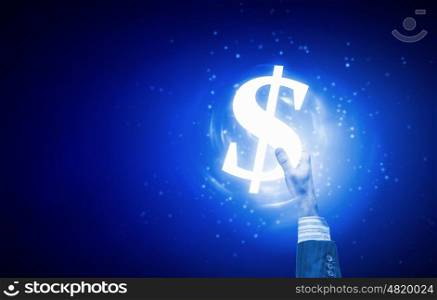 Dollar currency. Close up of human hand holding dollar symbol on blue background