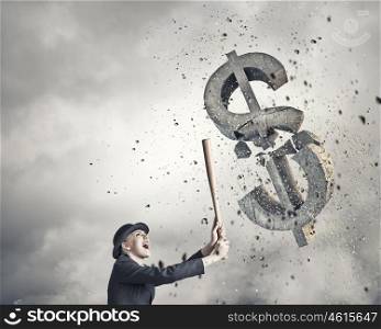 Dollar currency fall. Young pretty woman in suit and hat crashing dollar sign with baseball bat