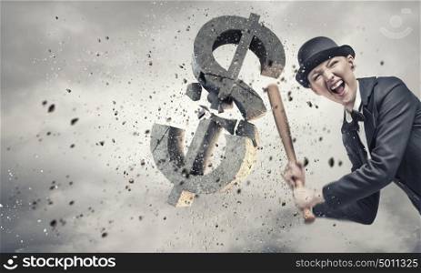 Dollar currency fall. Young pretty woman in suit and hat crashing dollar sign with baseball bat